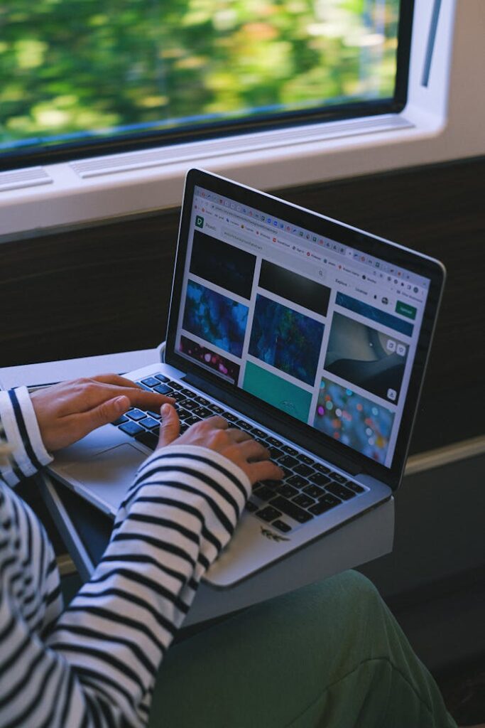 pexels-photo-12663327 Woman using a laptop on a train, symbolizing digital nomad lifestyle and remote work.